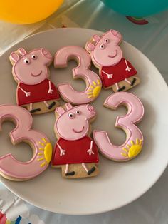 some peppa pig cookies are on a plate