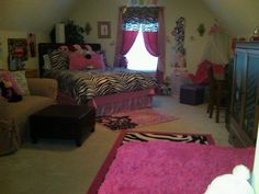 a bedroom with zebra print bedding and pink rugs