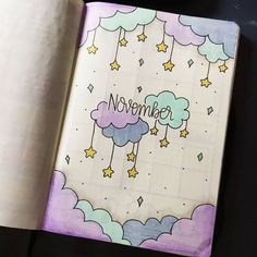 an open notebook with the words november written on it and stars in the sky above