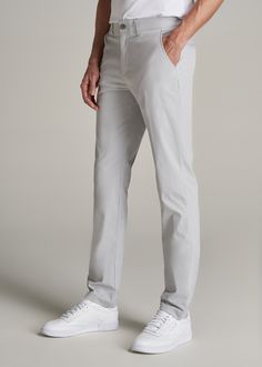 About Our Men's Tall Pants These extra-long chinos strike the perfect balance between classic and comfortable. They're designed to look like a pair of tapered chinos but are made of a lighter stretchy fabric that provides plenty of room for movement so you can tee off on the golf course, take the dog for a walk or grab dinner with friends at that new restaurant in town. We know how hard it is to find men's tall pants, which is why we made sure this pair had an extra-long inseam measured specific High Water Dress Pants Men, Light Grey Pants Outfit, Grey Mens Suit, Grey Pants Outfit, Grey Pants Men, Men Ootd, Tapered Chinos, Mens Slacks, Grey Chinos