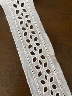 a piece of white lace sitting on top of a table