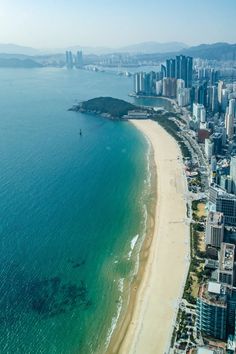 an aerial view of the beach and city skyline