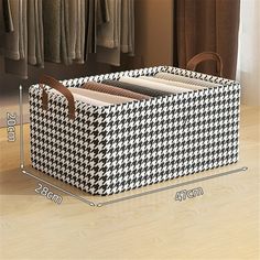 a large black and white checkered storage bin with two compartments on each side, next to a chair