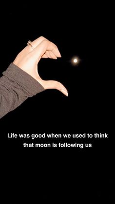 a person's hand with a ring on it that says life was good when we used to think that moon is following us