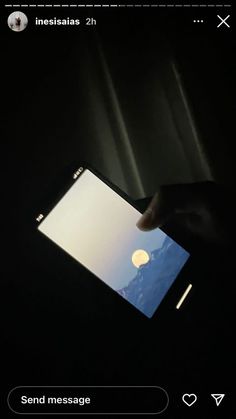 someone holding an iphone in their hand with the screen lit up at night and there is no image on it