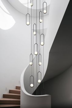 a spiral staircase with many lights hanging from it