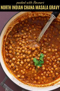 a pot filled with chickpeas and garnished with parsley on top