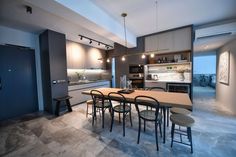 an open kitchen and dining room with modern lighting