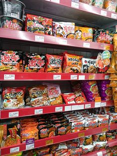 shelves in a grocery store filled with lots of different types of snacks and condiments