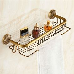 a gold towel rack with two bottles on it next to a white towel and some other items