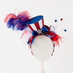 This 4th of July headband is the perfect accessory to show off your patriotic pride during Independence Day celebrations. Featuring sparkly red, white, and blue on a comfortable elastic band, this headband is a fun and festive way to complete your holiday outfit. Stand out at fireworks shows, backyard barbecues, and parades with this stylish and patriotic accessory. Dimensions: 11" Color: red, white, blue Cheap American Hats For Memorial Day, Cheap 4th Of July Cap, Cheap Patriotic Cap For 4th Of July, Cheap American Hats For 4th Of July, Cheap Patriotic Adjustable Hats, Cheap American Flag Hat For Memorial Day, Usa Fancy Dress, Patriotic Headband, Patriotic Centerpieces