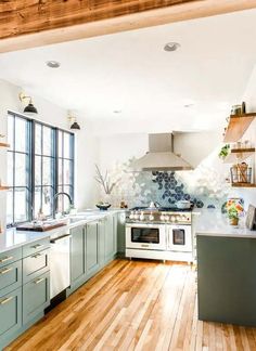 a kitchen with wooden floors and blue cabinets