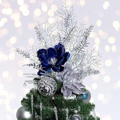 a christmas tree with ornaments and flowers on it