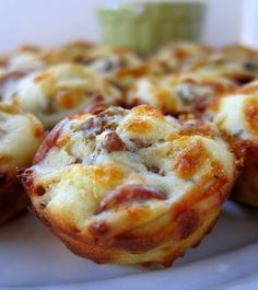 several small pizzas on a white plate