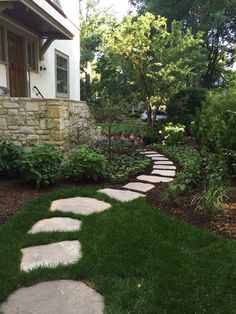 a stone path in front of a house