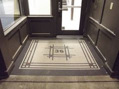 an entrance to a building with a tiled floor