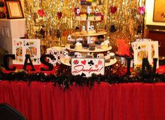 a red table topped with cards and cakes