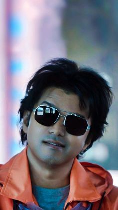 a man wearing sunglasses and an orange jacket