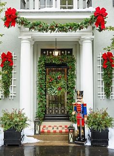 christmas decorations adorn the front door of a house