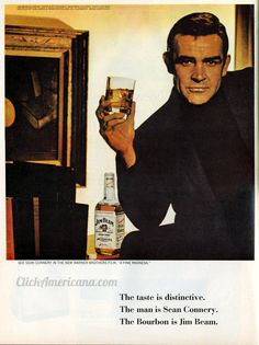 an advertisement for bourbon with a man holding a glass in front of him and the caption reads, the time is distinctive