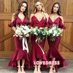 three women in red dresses standing next to each other with bouquets on their laps