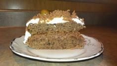 a piece of cake sitting on top of a white plate with frosting and toppings