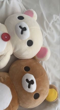 three teddy bears laying on top of each other