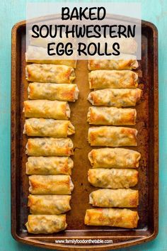 baked southwestern egg rolls on a baking sheet with text overlay that reads baked southwestern egg rolls