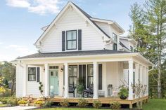 a white house with black shutters on the front porch