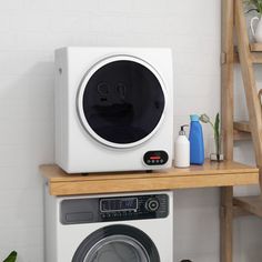 a washing machine sitting on top of a wooden shelf