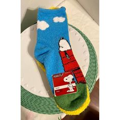 a pair of socks with snoopy on them are sitting on a plate next to a napkin