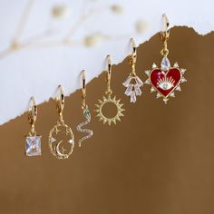 "Summer Jewelry, Huggie Hoops Gold, Dainty Earrings, Evil Eye Earrings, Sun Snake Heart Charm, Cubic Zircon Hoop Earrings, Baguette Hoop ✨These earrings feature a charm of your choice hanging from a dainty 18k Gold Plated huggie hoop. These hoops are sold as SINGLES, or by PAIRS - both options are available to select from the 2nd drop down menu. Mix & match these earrings to create fun and unique pairs! * Bezeled Moonstone Hoop Available to Purchase HERE: https://www.etsy.com/listing/1253212496/ Gold Hoop Heart Earrings For Party, Gold Heart Hoop Earrings For Party, Trendy Hoop Earrings With Dangling Charms As Gift, Hoop Earrings With Charms For Jewelry Making, Single Hoop Clip-on Earring As A Gift, Huggie Earrings With Dangling Charms As Gift, Party Dangle Huggie Earrings, Trendy Charms Earrings As Gift, Trendy Charms Earrings For Gift