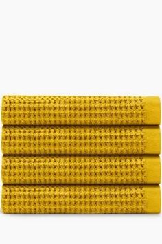 three yellow towels stacked on top of each other