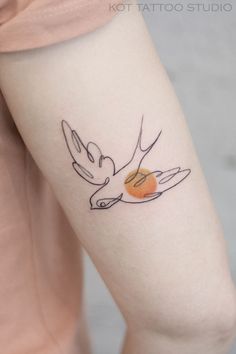 a woman's arm with a bird tattoo on the left side of her body