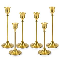 six gold candlesticks are lined up in a row