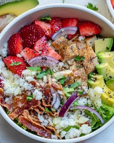 a white bowl filled with rice, fruit and meat