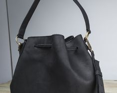 "I create my bags with high attention for details and I always respect high standards of quality. For this bag I used a soft Italian leather that gives a pleasant feeling at touch and I added all the features you would like to have on a bucket bag. The inside is fully lined and it has 3 pockets, one of them closed with a zipper for quick-access items, where you can keep your keys, your phone and other small thing that we normally lose in the abyss of our bags. To have a more secured bag, it clos Black Bucket Hobo Bag With Handle Drop, Soft Leather Bucket Shoulder Bag As Gift, Daily Use Bucket Bag With Handle Drop, Black Bucket-shaped Bags For On-the-go, Black Bucket Bags For On-the-go, Daily Use Shoulder Bag With Bucket Shape, Daily Use Shoulder Bag With Handle Drop, Black Pouch Bucket Bag As Gift, Black Shoulder Bucket Bag Gift