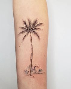 a palm tree tattoo on the right thigh