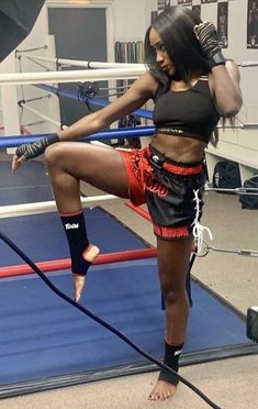 a woman standing on top of a boxing ring