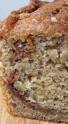 a loaf of banana bread sitting on top of a wooden cutting board