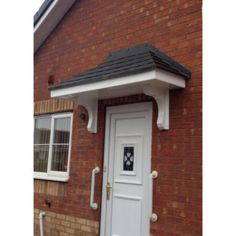 a white front door on a brick house