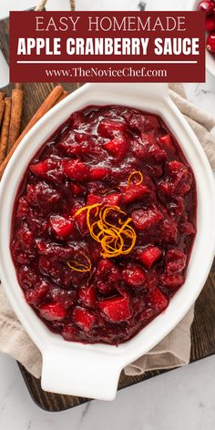 an apple cranberry sauce in a white bowl with cinnamon sticks on the side