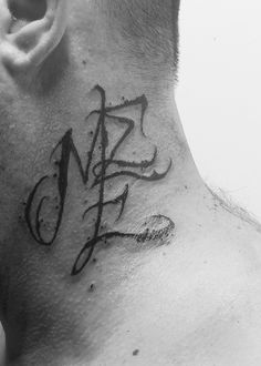 a man with a tattoo on his neck has the letters m and f written in cursive ink