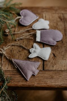 three ornaments are hanging on a wooden table