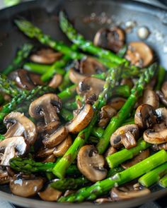 asparagus and mushrooms cooking in a wok