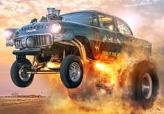 an old truck is flying through the air with flames coming out of it's tires