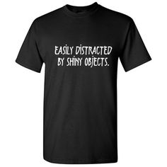 Easily Distracted By Shiny Objects Novelty Humorous Sarcastic Sayings Graphic Tee Holiday Gift Apparel For Christmas Vacations Funny Mens T Shirt Get Your Daily Dose of Humor With These Hilarious Funny T Shirts Road Kill T shirts has a line of exceptionally funny t shirts that are perfect for those who are looking for edgy novelty T shirts to wear. If you are the type of person who likes to wear a graphic black tee with a funny quote or a witty comment, then these funny T shirts are perfect for Sarcastic Sayings, Vacation Humor, Shiny Objects, Easily Distracted, Tee Shirt Print, Christmas Vacation, Measurement Chart, Sarcastic Quotes, Funny T