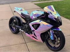 a colorful motorcycle parked on the side of a road