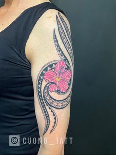 Polynesian with Hibiscus flower arm tattoo.