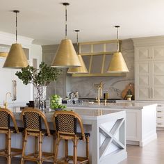 a kitchen with two bar stools next to an island